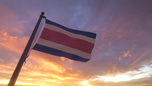 costa-rica-flag-on-flagpole-by-evening-sunset-sky-2024-11-26-10-37-43-utc-2