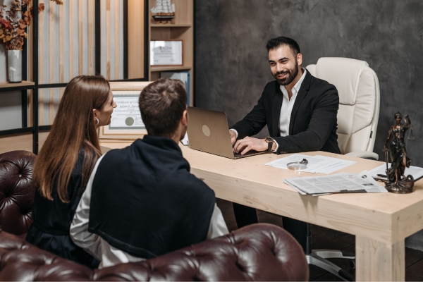 A Costa Rican lawyer provides legal consultation to a couple on residency application requirements and processes.